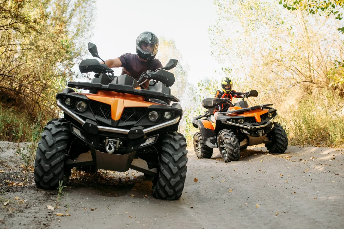 An image containing motorcycle, exterior, tree, terrain