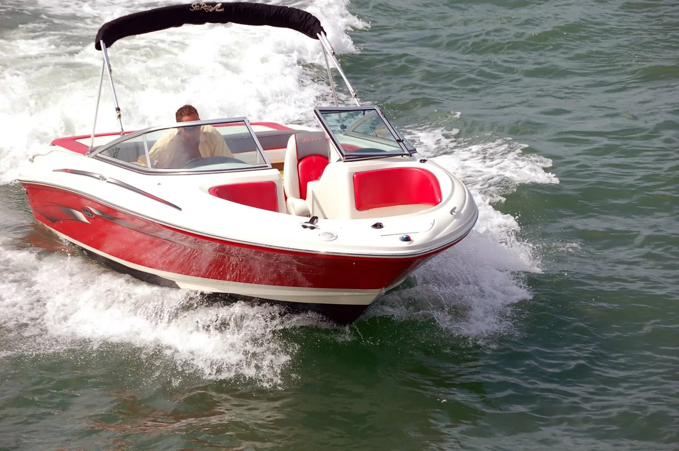 An image containing water, outdoors, boat, red